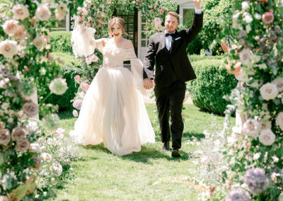 Bride and Groom holding hands and celebrating after wedding ceremony