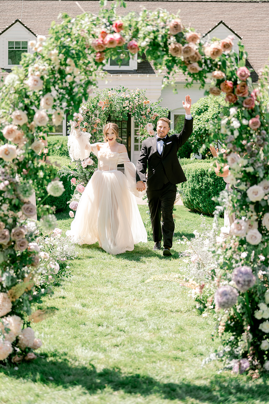 Bride and Groom holding hands and celebrating after wedding ceremony